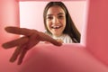 Happy and excited young woman looking inside carton box. Pleasant gift Royalty Free Stock Photo