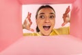 Happy and excited young woman looking inside carton box. Receiving long-awaited packages Royalty Free Stock Photo