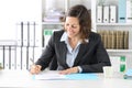 Happy executive lady signing contract at office Royalty Free Stock Photo