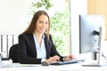 Happy executive looks at camera at office