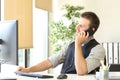 Happy executive is talking on phone at office