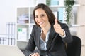 Happy executive gesturing thumbs up at office Royalty Free Stock Photo