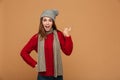 Happy exited pretty woman in winter clothes showing thumb up gesture, looking at camera Royalty Free Stock Photo