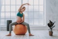 Happy expectant woman doing pilates on gymnastic ball at home Royalty Free Stock Photo