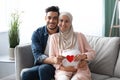 Happy Expectation. Muslim Couple Holding Red Paper Heart Near Woman's Pregnant Belly Royalty Free Stock Photo