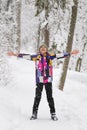 Happy expressive teenage girl enjoying the first snow standing with open arms in winter