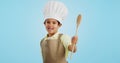 Happy, face and child with a spoon for baking, young chef or getting ready for the kitchen. Smile, boy kid or portrait Royalty Free Stock Photo