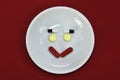 Happy face made of medicine. pain medication tablets. colored pills on porcelain dish. Assorted pharmaceutical pills