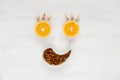Happy face of fruit and seeds. The smiling face is made of oranges, garlic and raisins on a white background. Background of useful Royalty Free Stock Photo