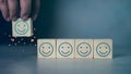Happy face icons on wooden cubes, customer satisfaction or teamwork concept. Customer service evaluation and satisfaction survey Royalty Free Stock Photo