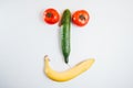 Happy face made with fresh fruits. Tomato, cucumber , banana. Royalty Free Stock Photo