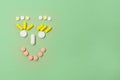 Happy Face Made of Variety Pills on Green Background Top View Copy Space Medical Concept Royalty Free Stock Photo