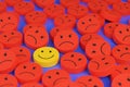 Happy face among many other angry faces. Positive attitude concept. 3d illustration