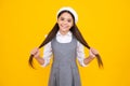 Happy face, positive and smiling emotions of teenager girl. Children studio portrait on yellow background. Childhood Royalty Free Stock Photo