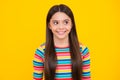 Happy face, positive and smiling emotions of teenager girl. Children studio portrait on yellow background. Childhood Royalty Free Stock Photo