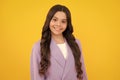 Happy face, positive and smiling emotions of teenager girl. Children studio portrait on yellow background. Childhood Royalty Free Stock Photo