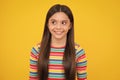 Happy face, positive and smiling emotions of teenager girl. Children studio portrait on yellow background. Childhood Royalty Free Stock Photo