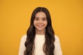 Happy face, positive and smiling emotions of teenager girl. Portrait of beautiful happy smiling teenage girl on yellow Royalty Free Stock Photo