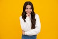 Happy face, positive and smiling emotions of teenager girl. Thoughtful teenage child girl on yellow background. Portrait Royalty Free Stock Photo