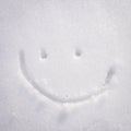 Happy face smiley drawn on white snow, frosty winter day Royalty Free Stock Photo