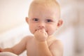 Happy, face and toddler standing in crib, bedroom or excited baby boy with hands on teething mouth in morning, nap or Royalty Free Stock Photo