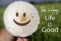 Happy face on a white mushroom on the grass with positive inspirational messages - Be happy. Life is good. Happiness with a smile