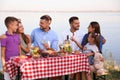 Happy families with little children at picnic table