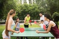 Happy families playing ping pong in park Royalty Free Stock Photo