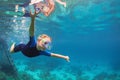 Child in snorkelling mask dive underwater with tropical fishes Royalty Free Stock Photo