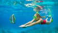 Young woman in snorkeling mask dive underwater with tropical fishes Royalty Free Stock Photo