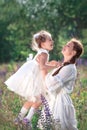 Happy family activities and outdoors lifestyle on a summer meadow with grass and flowers. Little girl child daughter playing and Royalty Free Stock Photo