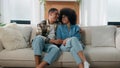 Happy family African American couple in love hugging at couch at home spending time together affectionate bonding man Royalty Free Stock Photo