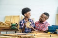 Happy family african american father and son carpenter gather craft a car out of wood and play, family concept to stay at home and Royalty Free Stock Photo