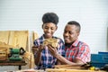 Happy family african american father and son carpenter gather craft a car out of wood and play, family concept to stay at home Royalty Free Stock Photo