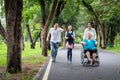 Happy family,asian little child girl or daughter playing tag game,running joyful with father,elderly in wheelchair,mother and