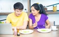 Happy family. Asian lovely couple, beautiful woman and handsome man are having breakfast in the kitchen Royalty Free Stock Photo