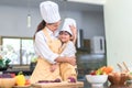 Happy family asian mom hugging little son cooking salad vegetable prepare healthy food