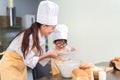 Happy family asian mom and son making bakery cake prepare delicious sweet food Royalty Free Stock Photo