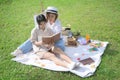 Happy family mother and daughter reading book together at the park. Royalty Free Stock Photo