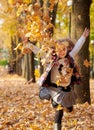 Happy family is in autumn city park. Children and parents running with leaves.. They posing, smiling, playing and having fun. Royalty Free Stock Photo
