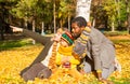 Happy family in autumn park. African American family: black father, mom and child boy on nature in fall. Royalty Free Stock Photo