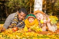 Happy family in autumn park. African American family: black father, mom and child boy on nature in fall. Royalty Free Stock Photo