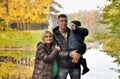 Happy family in autumn park near lake Royalty Free Stock Photo