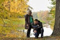 Happy family in autumn park near lake Royalty Free Stock Photo