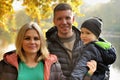 Happy family in autumn park near lake Royalty Free Stock Photo