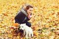 Happy family on autumn walk. Mother, daughter and their dog playing in the autumn park. Family enjoying beautiful fall nature. Aut Royalty Free Stock Photo