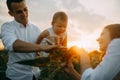 Happy family with baby has a fun and plays in the sunflower field Royalty Free Stock Photo