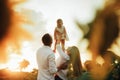 Happy family with baby has a fun and plays in the sunflower field Royalty Free Stock Photo