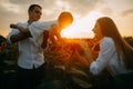 Happy family with baby has a fun and plays in the sunflower field Royalty Free Stock Photo