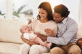 Happy family, baby and hug on sofa for bonding, support or love together in relax at home. Father and mother holding Royalty Free Stock Photo